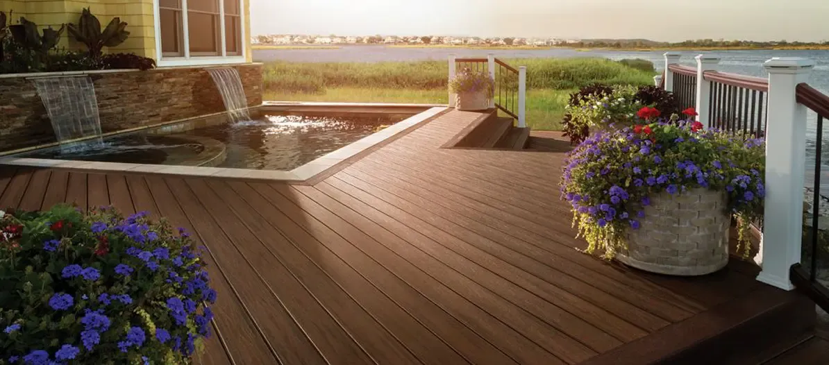 A newly-installed deck with built-in pool and water feature.