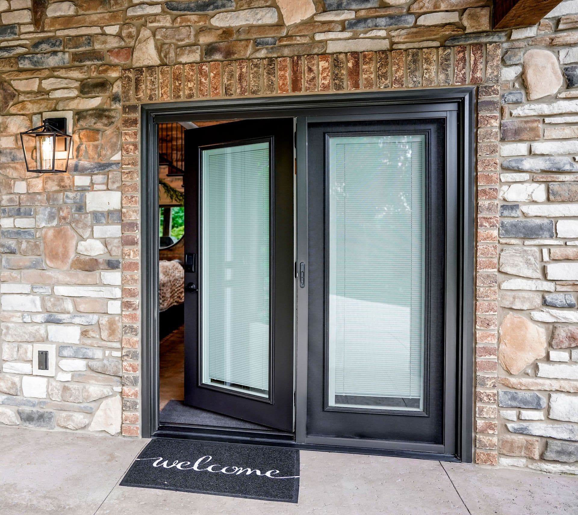 A ProVia Legacy™ 460 Smooth Hinged Patio Door in Rustic Bronze with White Internal Blinds.