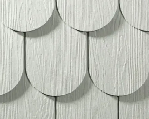 A swatch of rounded white James Hardie HardieShingle siding.